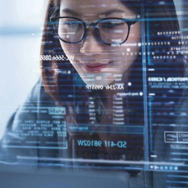 Woman analyzing data on transparent digital screen.